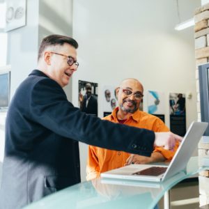 Sales Man Pointing At A Computer